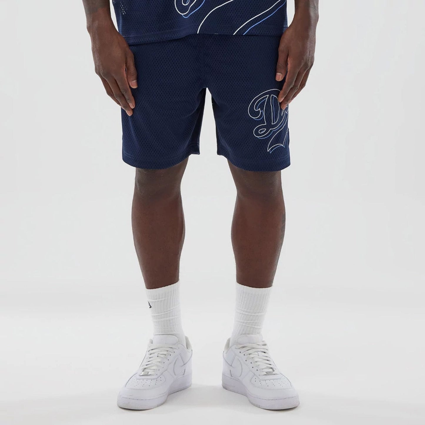 The model is wearing this MLB Mix League LA Dodgers Oversized Mesh Shorts in blue. 6