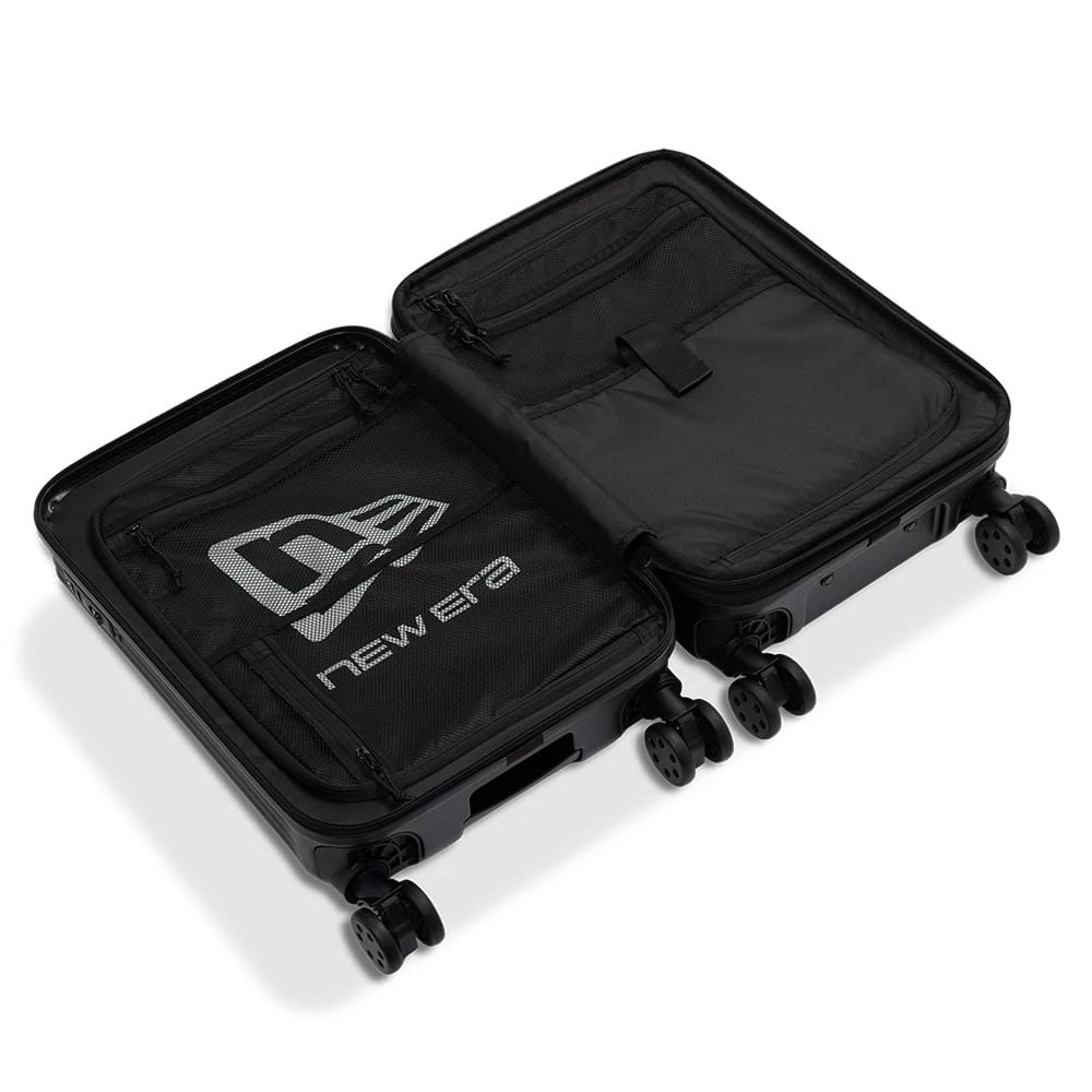 New Era Black Wheeled Cabin Case, open view showing the interior with two compartments, a large printed logo on the left panel, multiple zip pockets, and four spinner wheels attached to the black case.