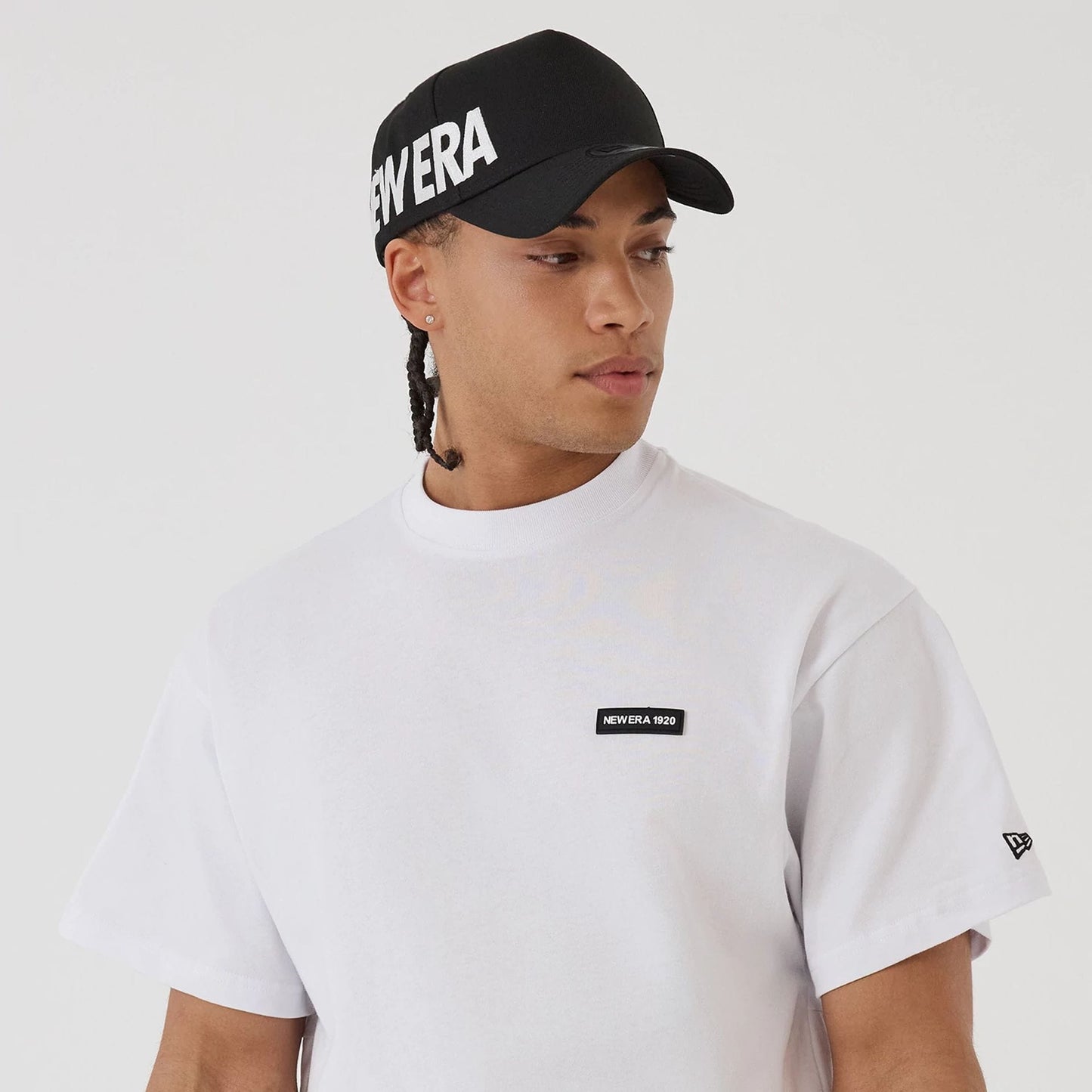 The model is wearing this New Era Distressed T-Shirt in white. 7