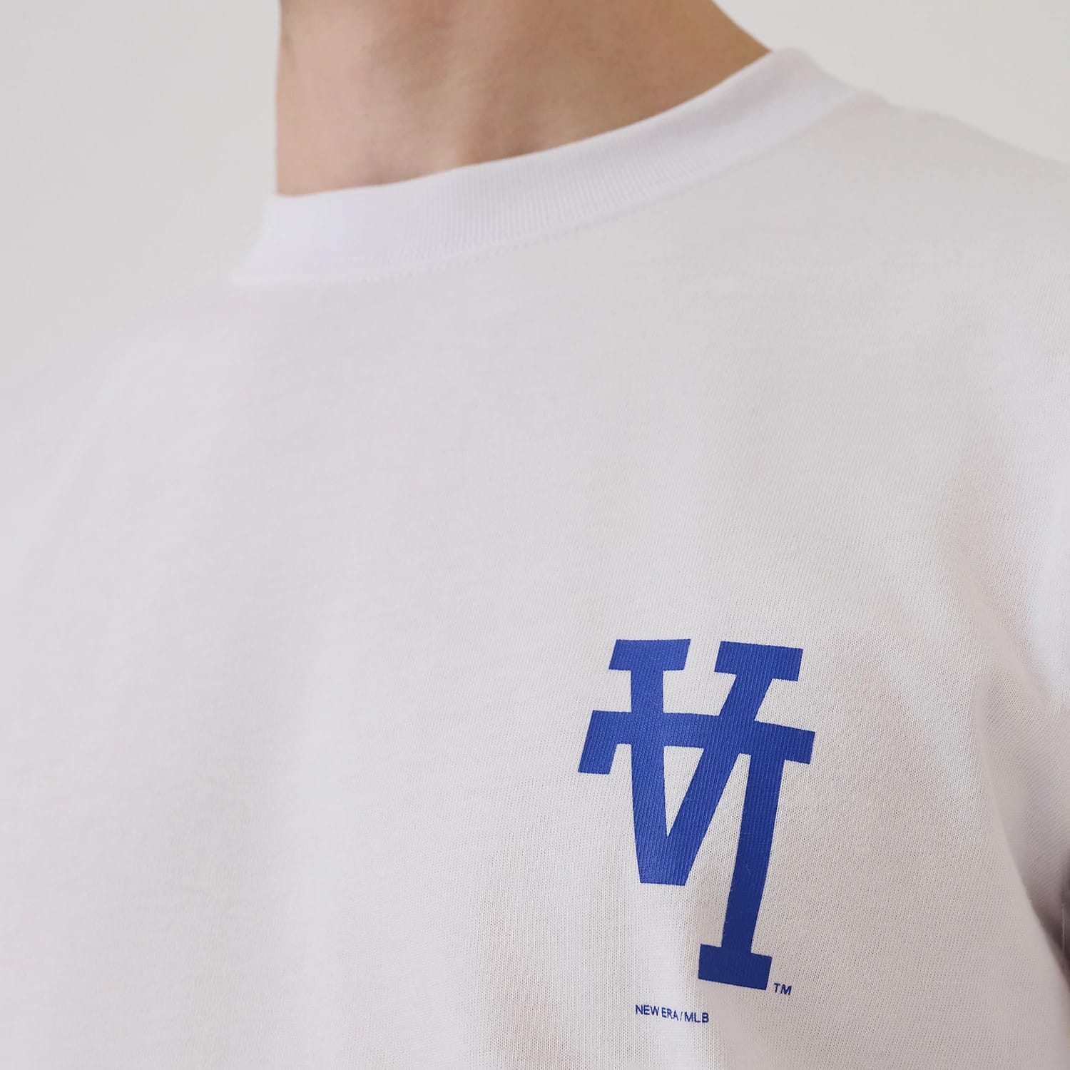 LA Dodgers MLB Upside Down White T-Shirt, front view showing a blue inverted "LA" logo printed on the left chest area, the plain white fabric contrasting with the bold logo beneath the crew neckline.