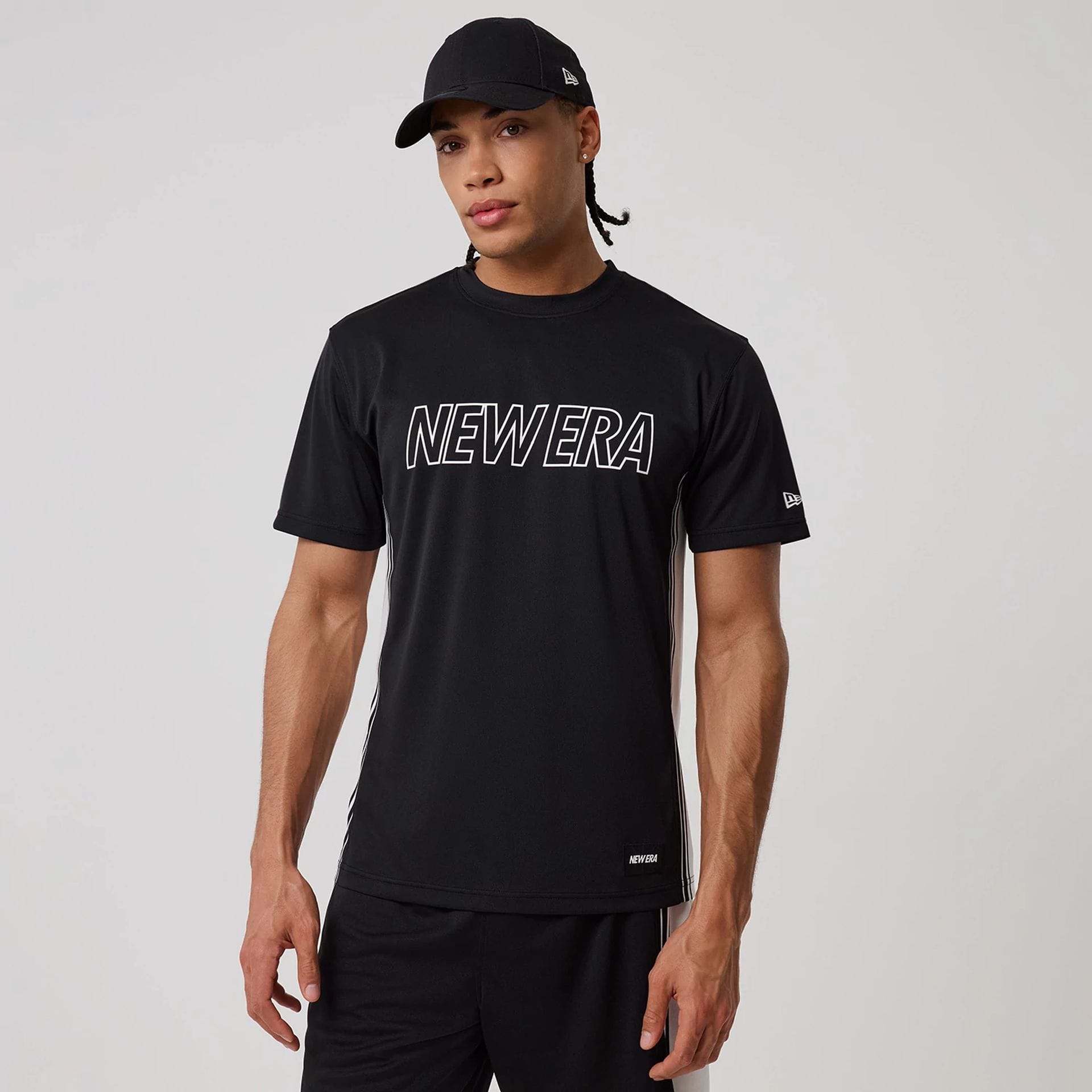 The model is wearing this New Era Mesh T-Shirt in black. 1