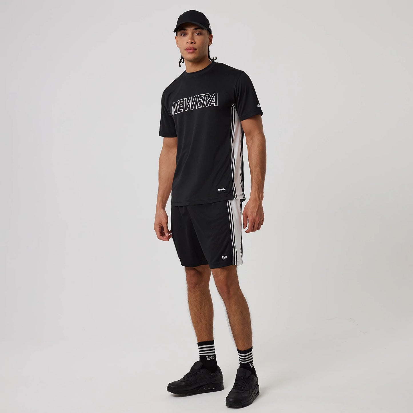 The model is wearing this New Era Mesh T-Shirt in black. 8
