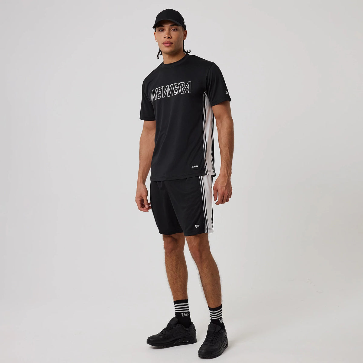 The model is wearing this New Era Mesh T-Shirt in black. 8