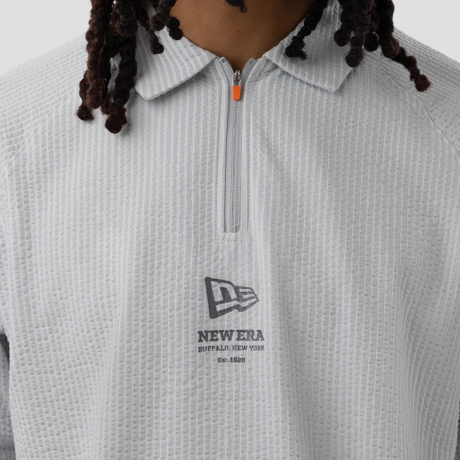 The model is wearing this New Era Seersucker Polo T-Shirt in grey. 4