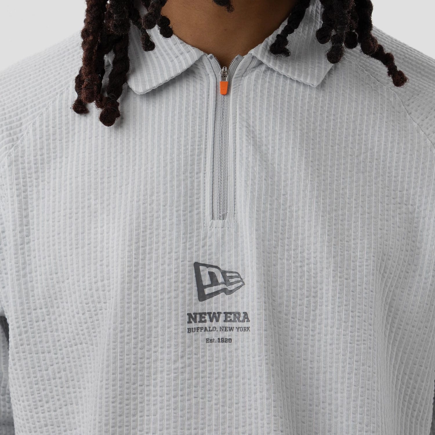 The model is wearing this New Era Seersucker Polo T-Shirt in grey. 4