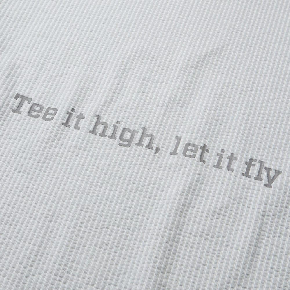 The model is wearing this New Era Seersucker Polo T-Shirt in grey. 8