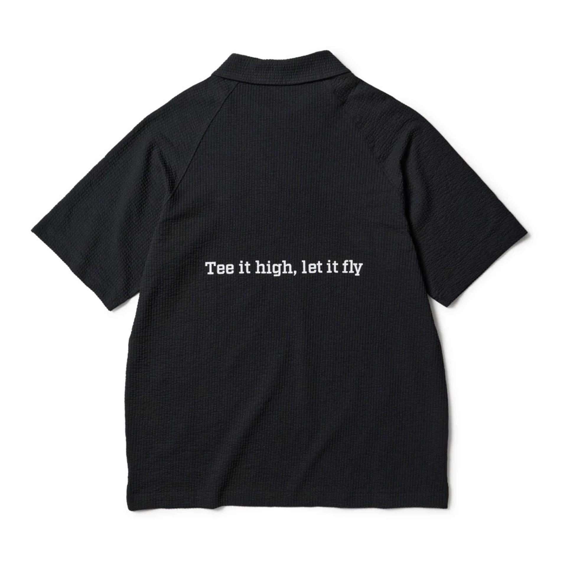 The model is wearing this New Era Seersucker Polo T-Shirt in black. 2