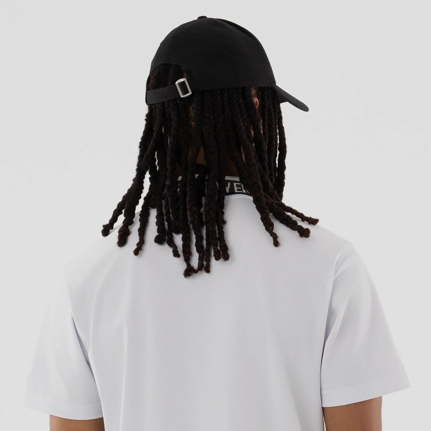 The model is wearing this New Era Kanoko Polo T-Shirt in white. 7