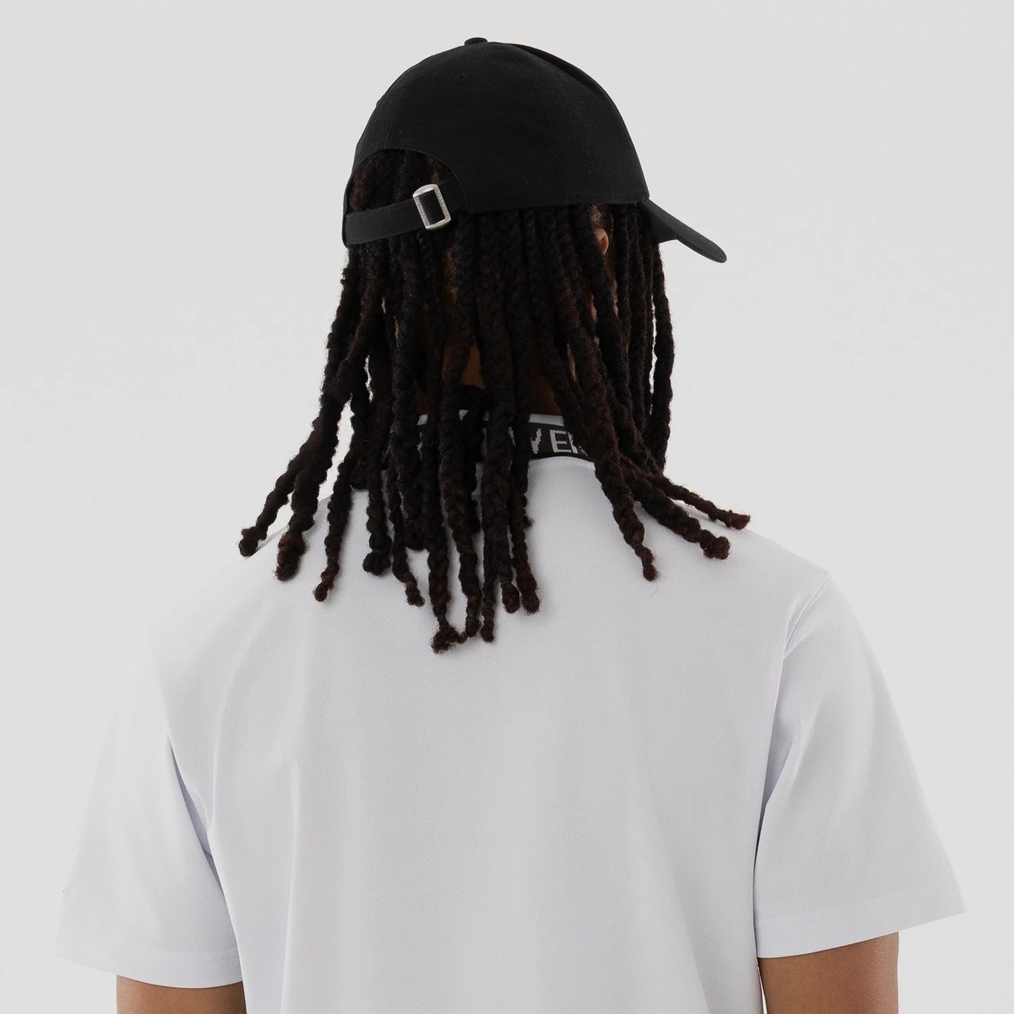 The model is wearing this New Era Kanoko Polo T-Shirt in white. 7