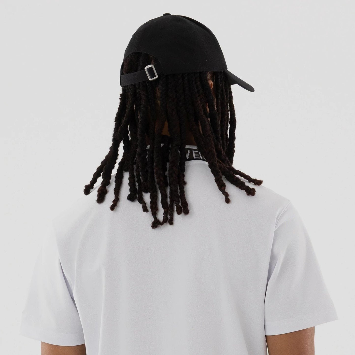 The model is wearing this New Era Kanoko Polo T-Shirt in white. 7
