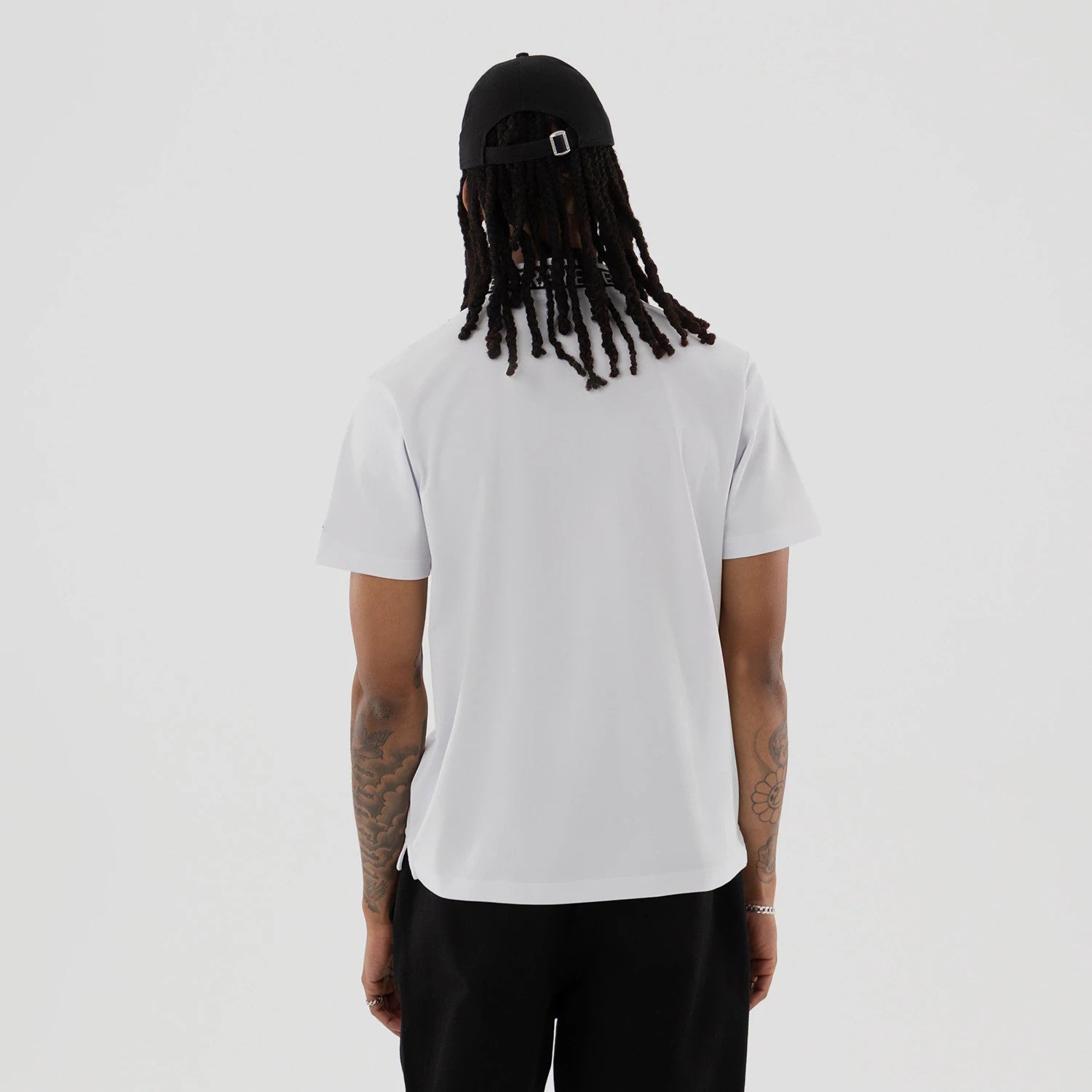 The model is wearing this New Era Kanoko Polo T-Shirt in white. 2