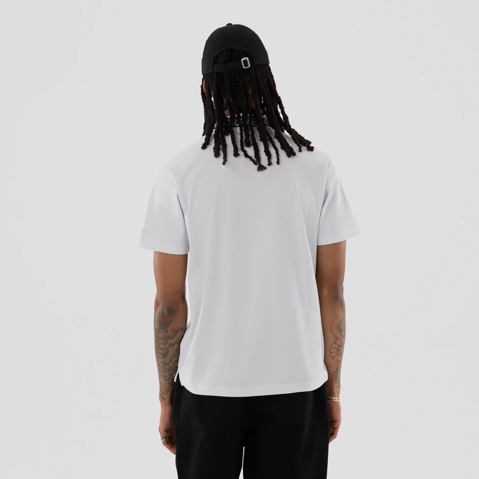 The model is wearing this New Era Kanoko Polo T-Shirt in white. 2