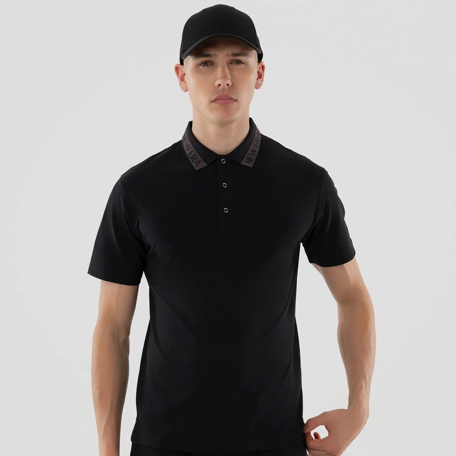 The model is wearing this New Era Kanoko Polo T-Shirt in black. 3