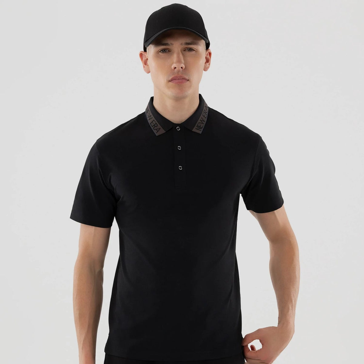 The model is wearing this New Era Kanoko Polo T-Shirt in black. 3