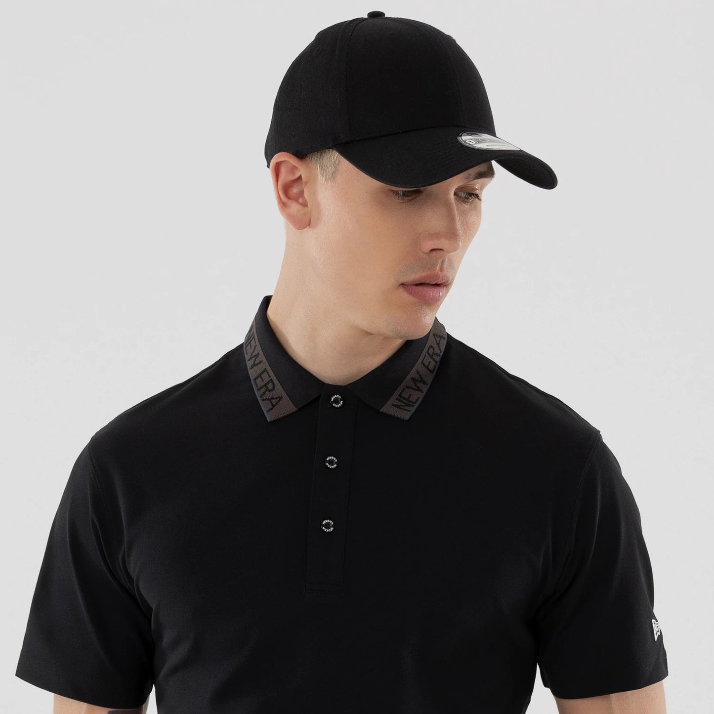 The model is wearing this New Era Kanoko Polo T-Shirt in black. 7