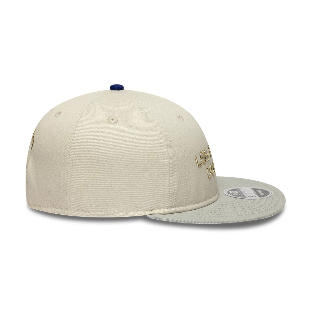 LA Dodgers Hajime Sorayama X MLB Cream Retro Crown New Era 9FIFTY Adjustable Cap, side view showing the gold LA Dodgers script logo on the cream panels with a grey visor and 9FIFTY size sticker.