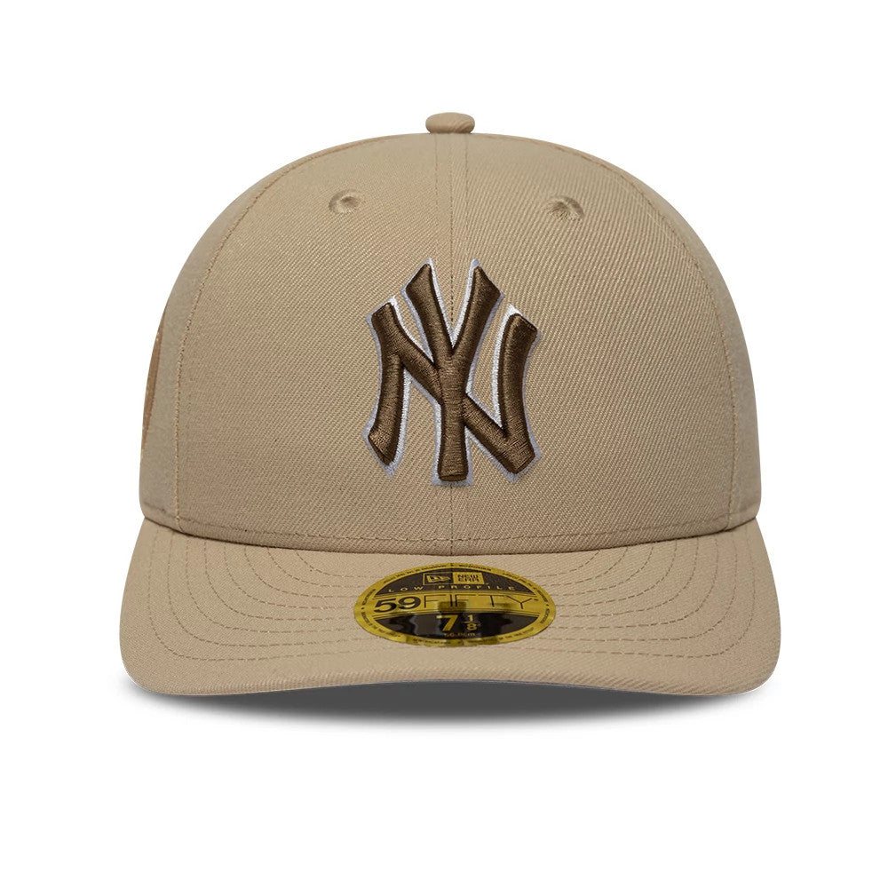 New York Yankees MLB College Varsity Beige Low Profile New Era 59FIFTY Fitted Cap, front view showing a raised brown NY logo on the central front panel and a gold 59FIFTY size sticker on the beige visor.