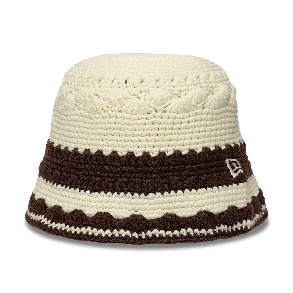 New Era Crochet Border White Explorer Bucket Hat, front view showing a cream crocheted crown with contrasting dark brown striped pattern and the New Era flag logo embroidered on the lower band.