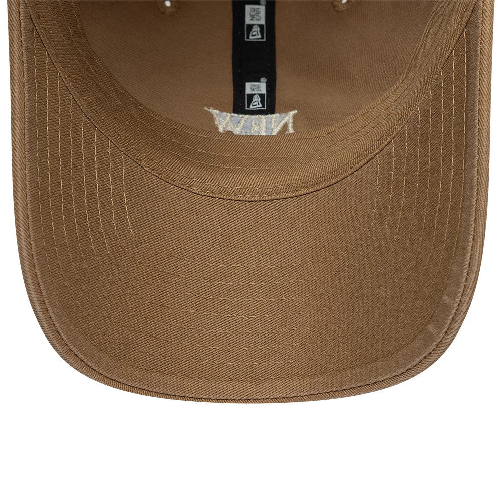 New Era Square Logo Dark Beige Casual Classic Adjustable Cap, inside view showing the black taping with branding and stitching detail on the brown undervisor, with eyelets positioned at the top.