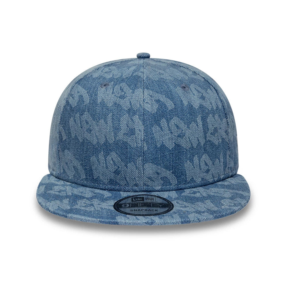 New Era Laser Burnout Washed Denim Navy New Era 9FIFTY Snapback Adjustable Cap, front view showing the all-over navy graffiti text pattern, a structured crown, a flat visor, and a 9FIFTY size sticker on the visor.