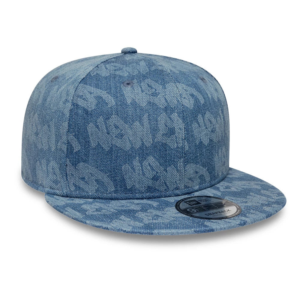 New Era Laser Burnout Washed Denim Navy New Era 9FIFTY Snapback Adjustable Cap, front view showing an all-over laser burnout print with a flat visor and a 9FIFTY size sticker on top, centred under the structured crown.