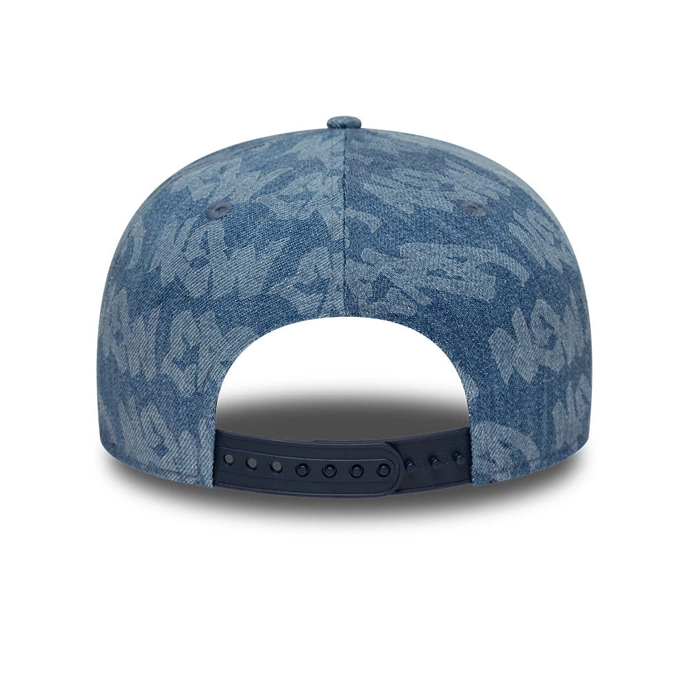 New Era Laser Burnout Washed Denim Navy 9FIFTY Snapback Adjustable Cap, rear view showing the adjustable navy snapback closure and a light blue laser burnout pattern across the denim fabric.