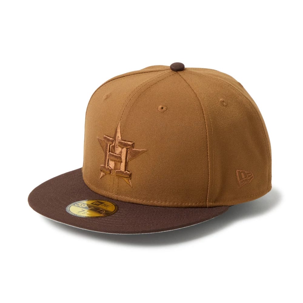 Houston Astros MLB Brown New Era 59FIFTY Fitted Cap, three-quarter view with a brown flat visor and gold 59FIFTY size sticker, featuring a raised embroidered Astros logo on the front panel and New Era flag logo on the left side.