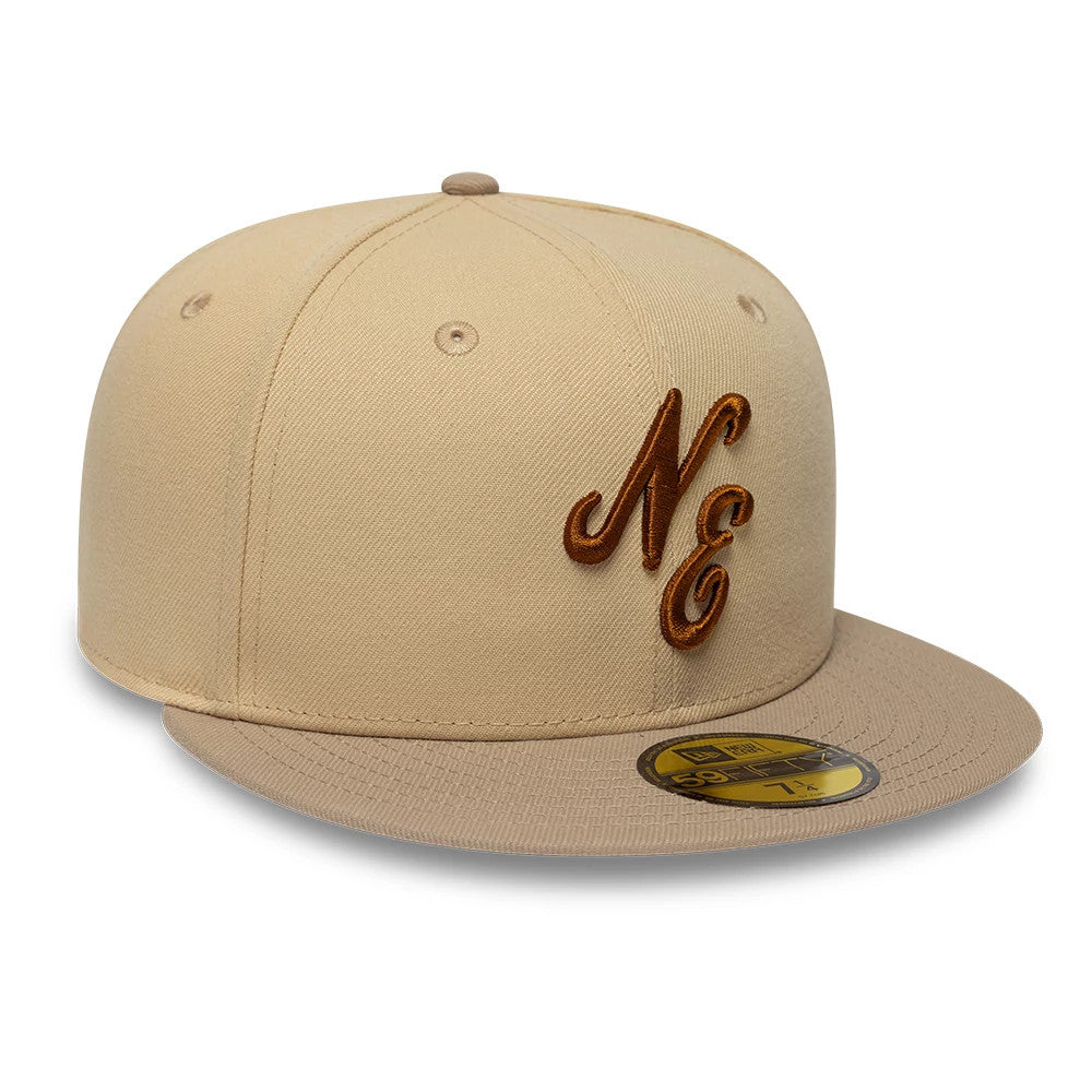 New Era Mocha Mousse Light Beige 59FIFTY Fitted Cap, three-quarter view showing raised brown embroidered "NE" initials on the front panel, beige visor, top button, and gold 59FIFTY size sticker on the visor.