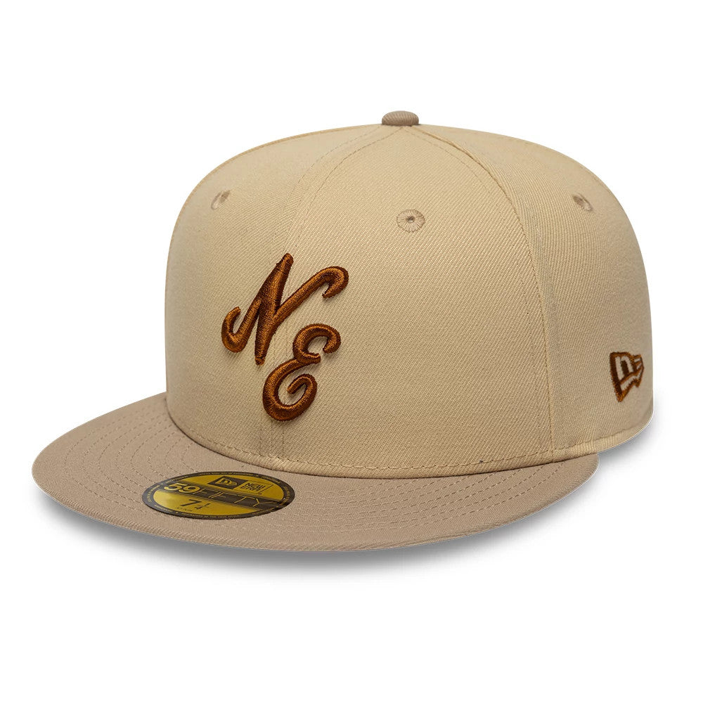 New Era Mocha Mousse Light Beige 59FIFTY Fitted Cap, three-quarter view showing raised brown NE embroidery on the front panel, matching light beige visor with gold 59FIFTY size sticker, and New Era flag logo on the left side.
