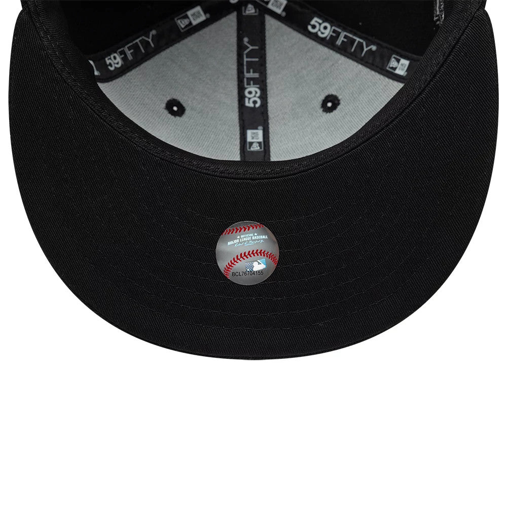 Chicago White Sox MLB Black On Black New Era 59FIFTY Fitted Cap, inside view showing the grey sweatband, black taped seams with 59FIFTY branding, and an MLB holographic sticker on the underside of the black visor.