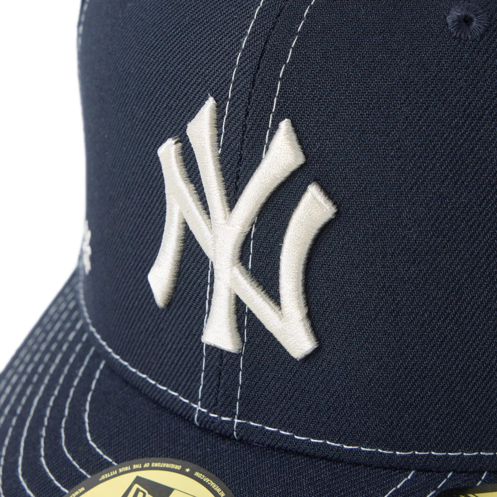 New York Yankees MLB Floral Navy New Era 59FIFTY Fitted Cap, three-quarter view showing raised white embroidered NY logo on the front panel, with a gold 59FIFTY size sticker on the navy visor and contrasting white stitching.