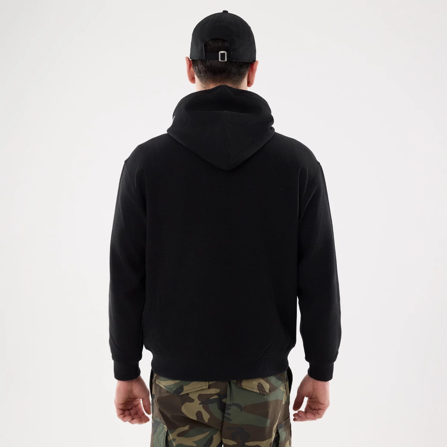 The model is wearing this New Era Waffle Full Zip Hoodie in black. 2