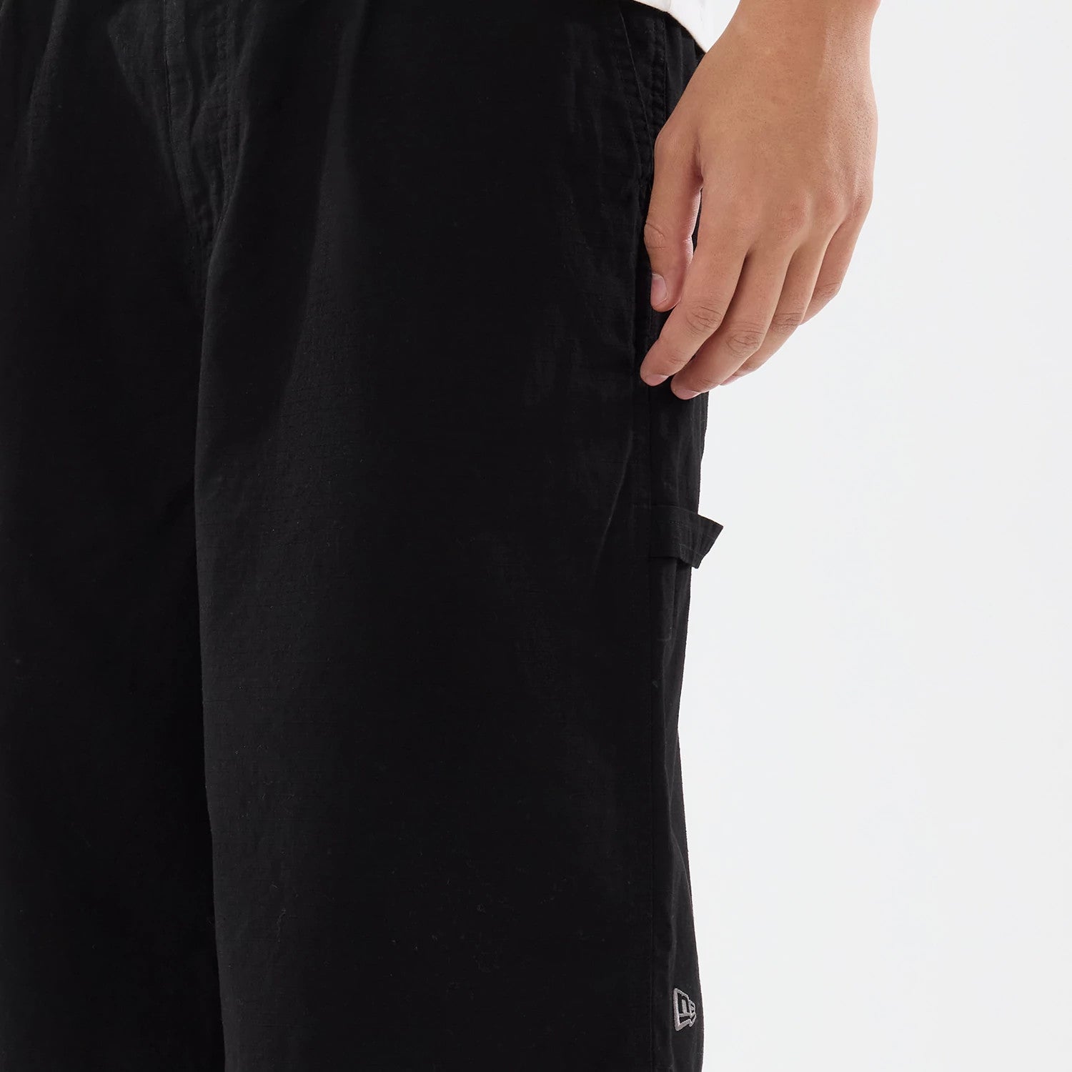 The model is wearing this New Era Canvas Bermuda Shorts in black. 4