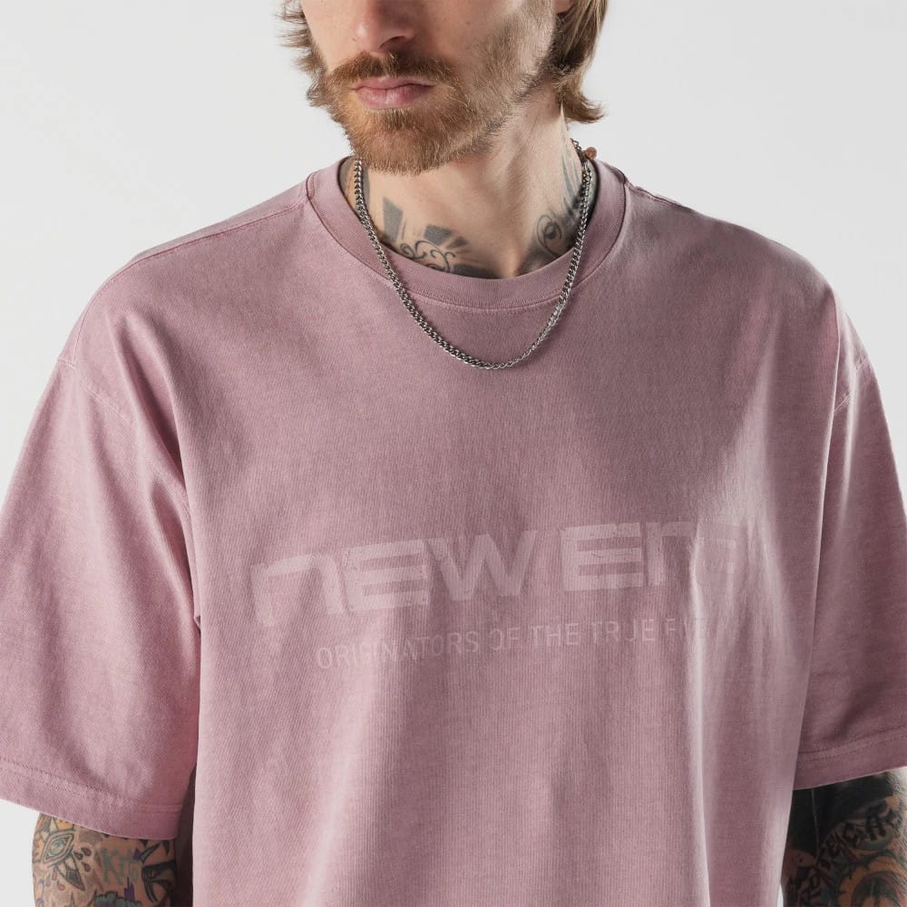 New Era Originators Pink T-Shirt, front view showing a pink T-shirt with a large embossed New Era logo across the chest, the words 'Originators of the True Fit' below, and short sleeves.