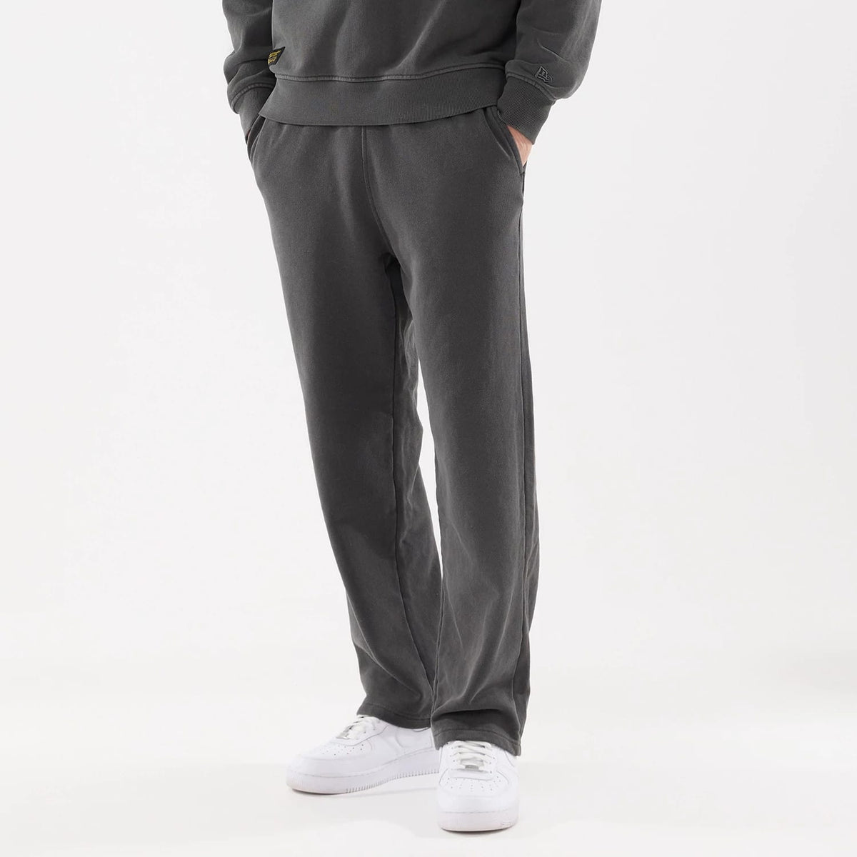 The model is wearing this New Era Originators Straight Leg Joggers in black. 1