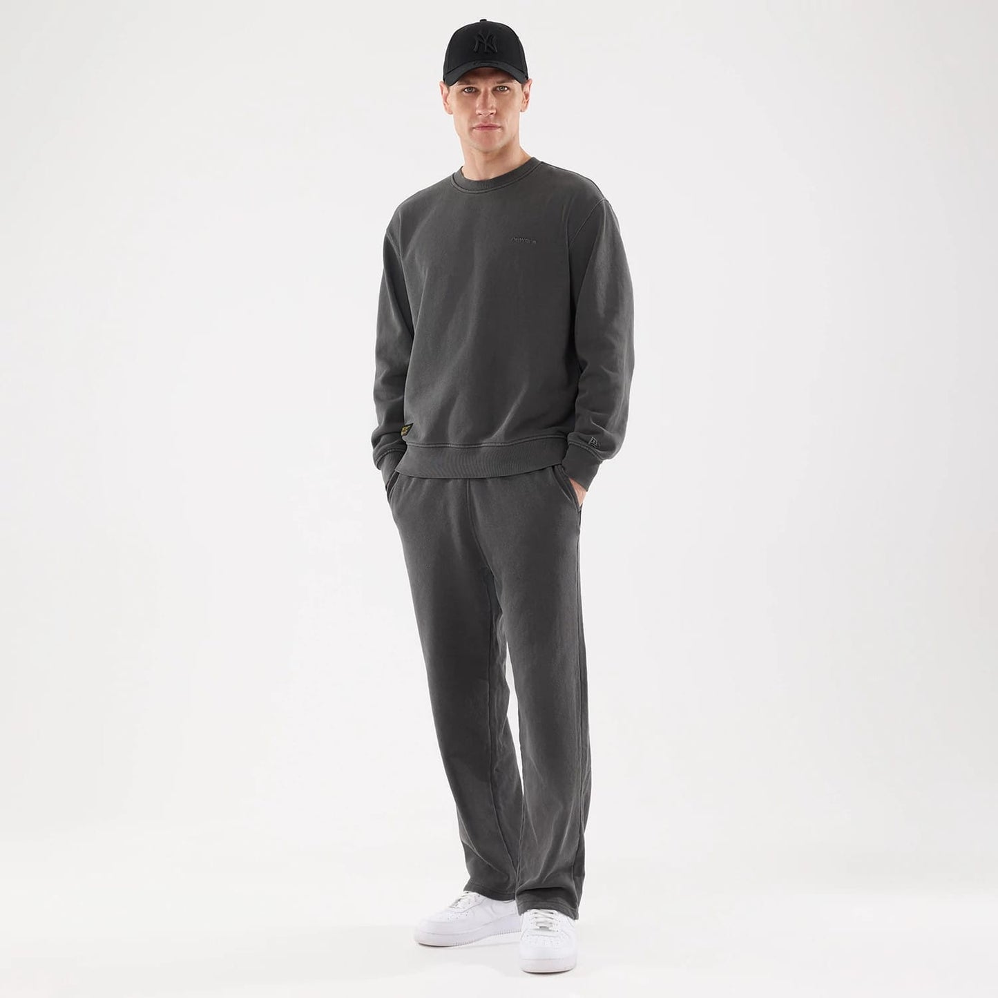 The model is wearing this New Era Originators Straight Leg Joggers in black. 8