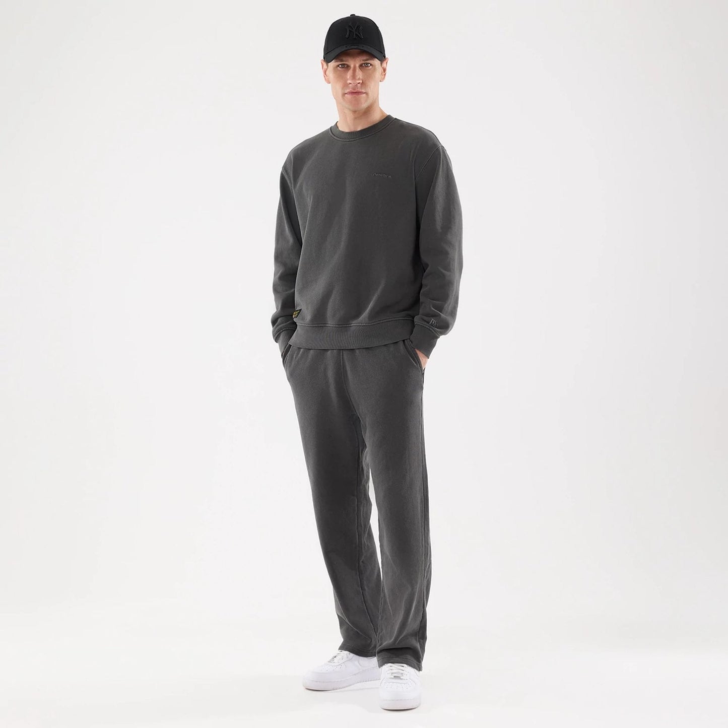 The model is wearing this New Era Originators Straight Leg Joggers in black. 8