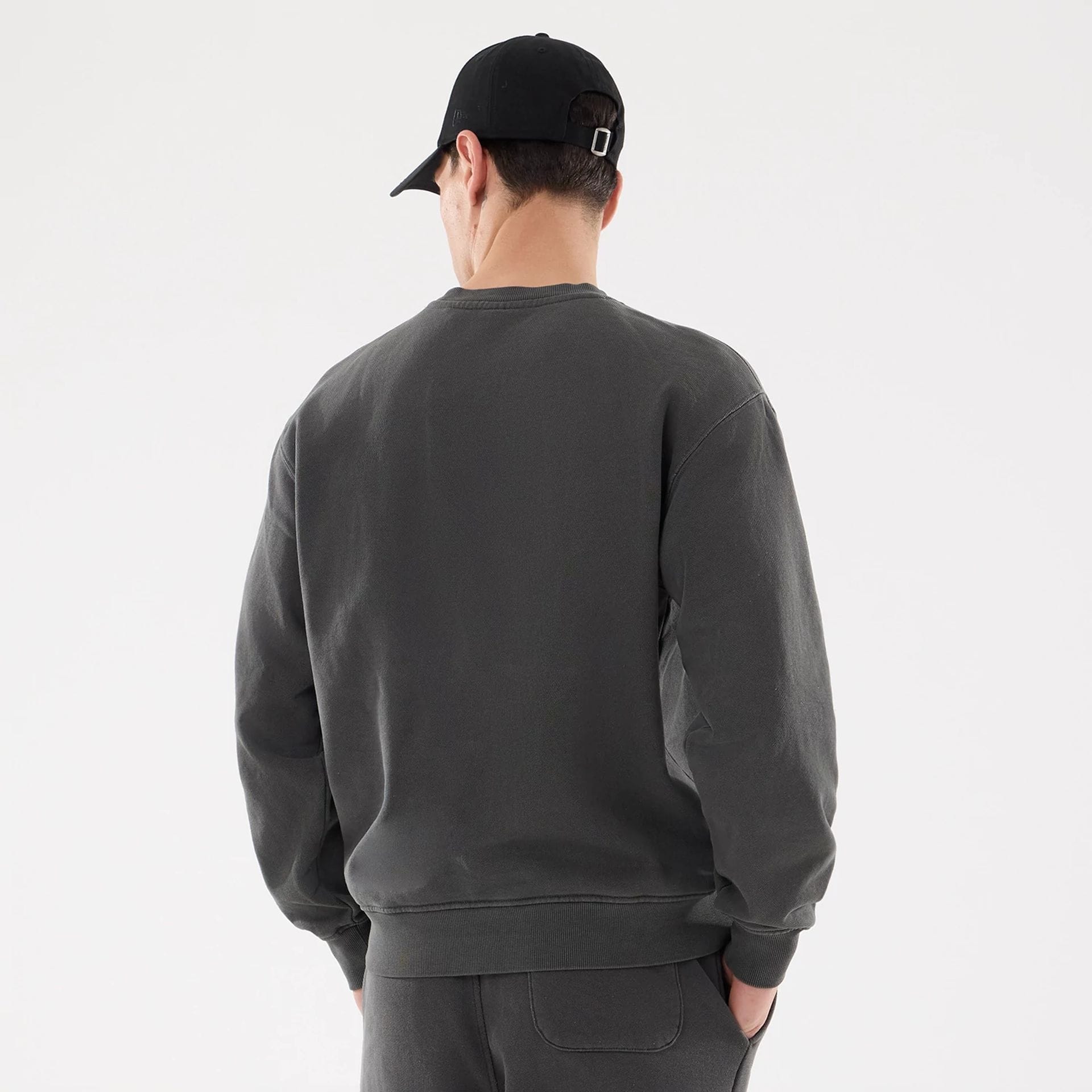The model is wearing this New Era Originators Crew Neck Sweater in black. 2