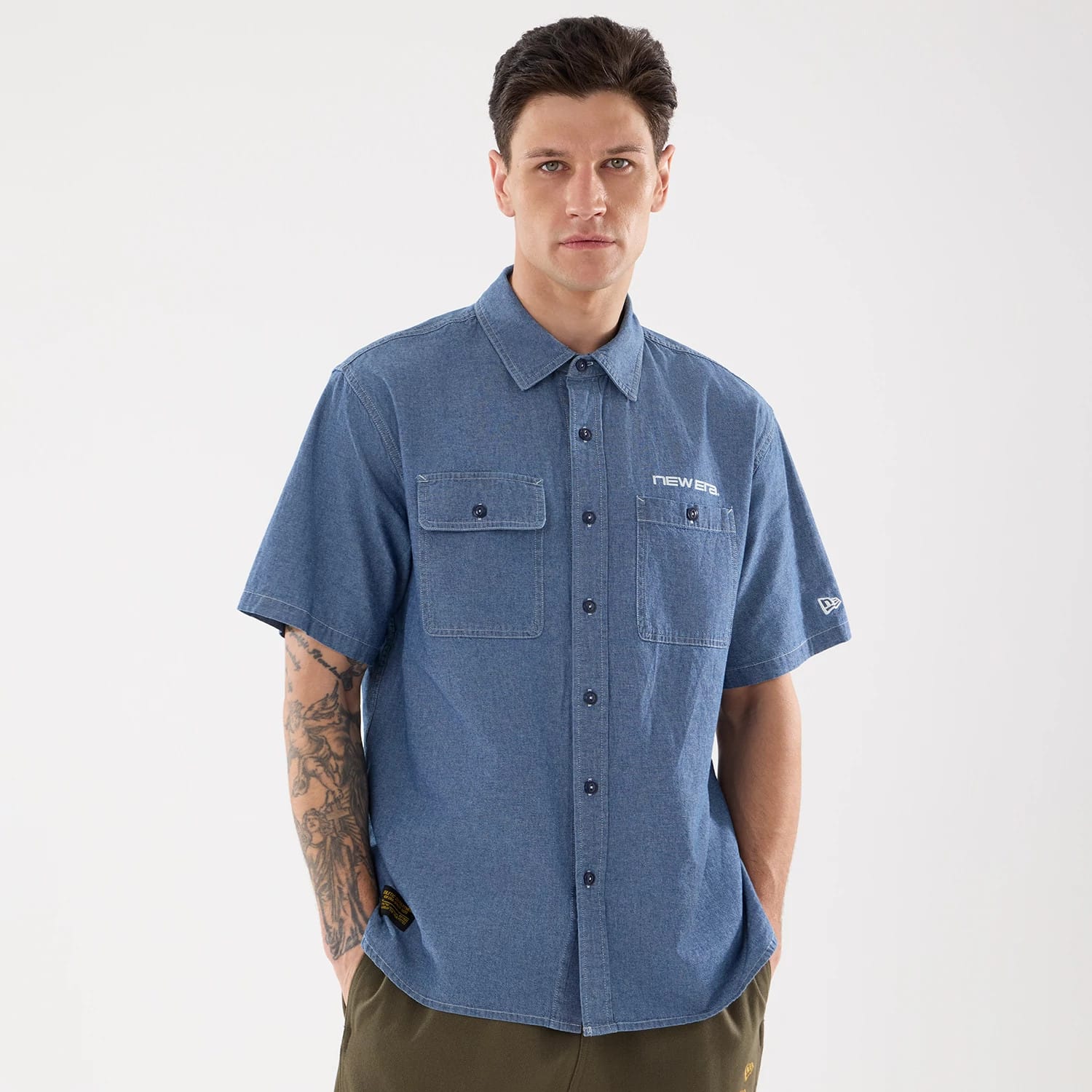The model is wearing this New Era Originators Chambray Short Sleeve Shirt in dark blue. 1