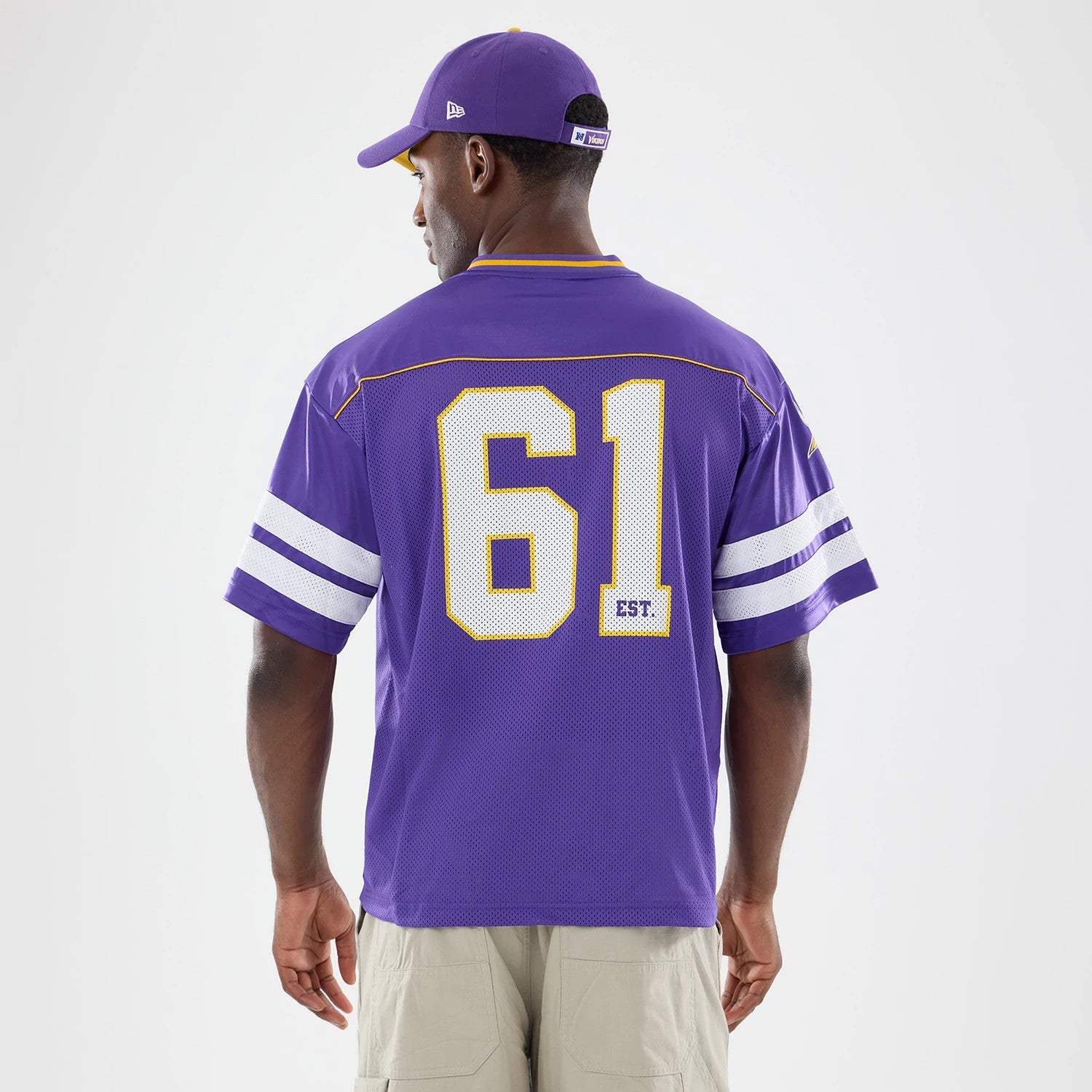 Minnesota Vikings NFL Purple Mesh Jersey, back view on a model wearing a matching purple cap, showing the large white number 61 in the centre, with white and purple stripe detailing on the sleeves.