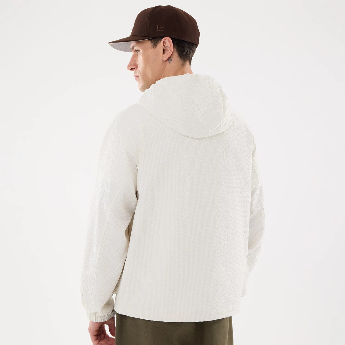 The model is wearing this New Era Black Label Jacket in open white. 2