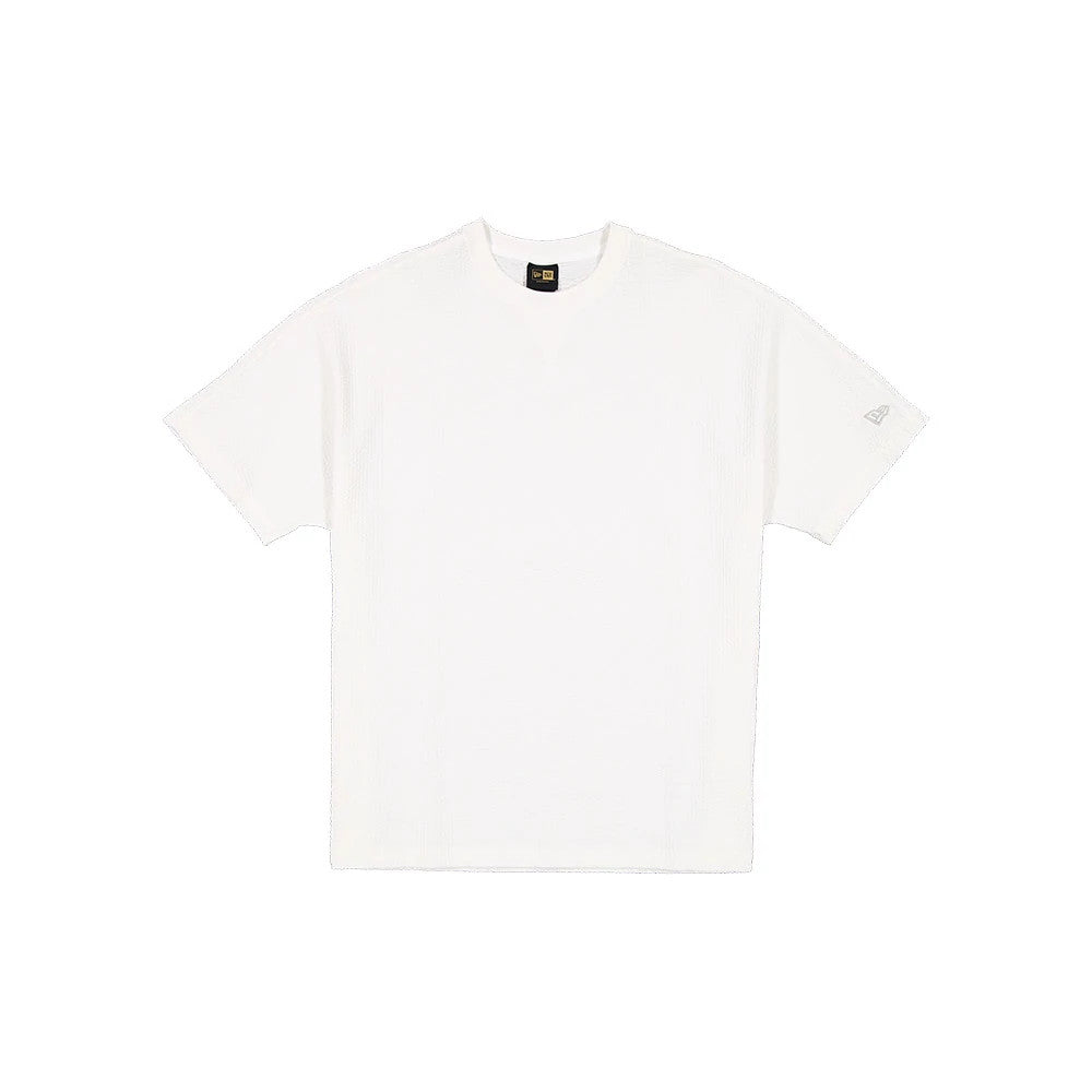 The model is wearing this New Era Black Label Seersucker T-Shirt in Cream. 1