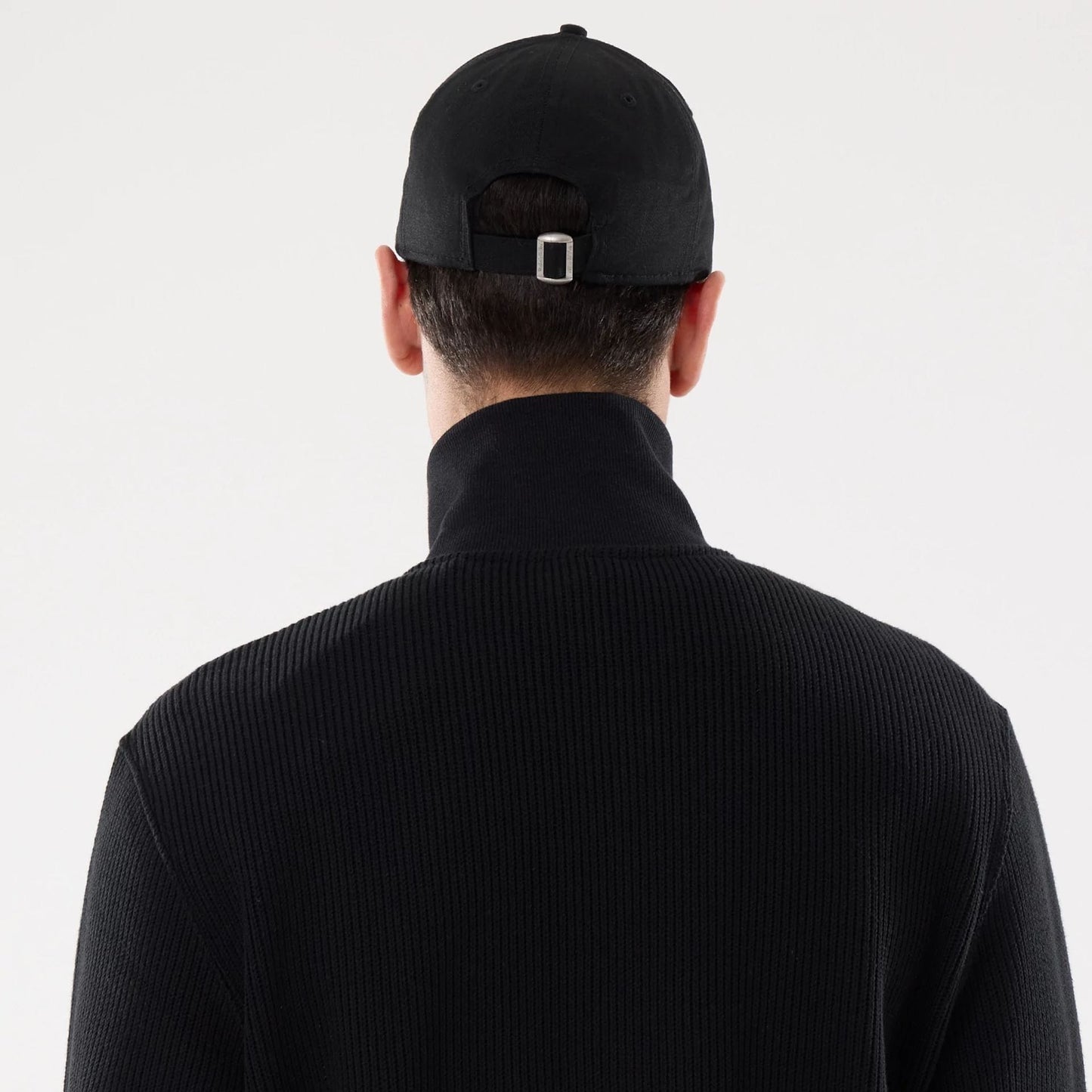 The model is wearing this New Era Black Label Jacket in black. 7
