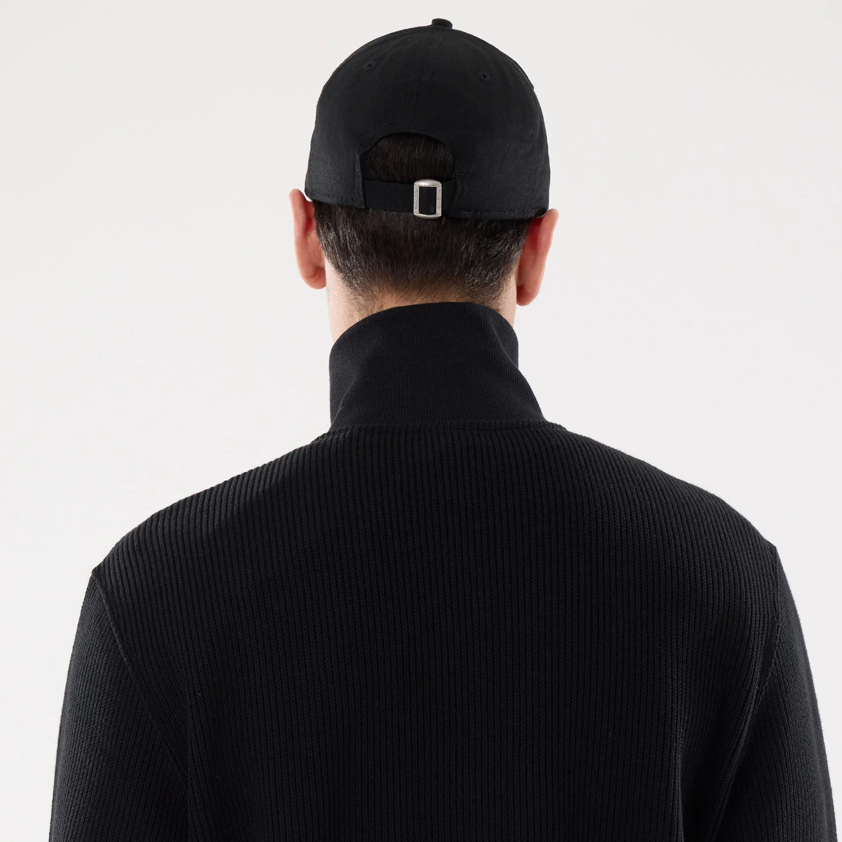 The model is wearing this New Era Black Label Jacket in black. 7