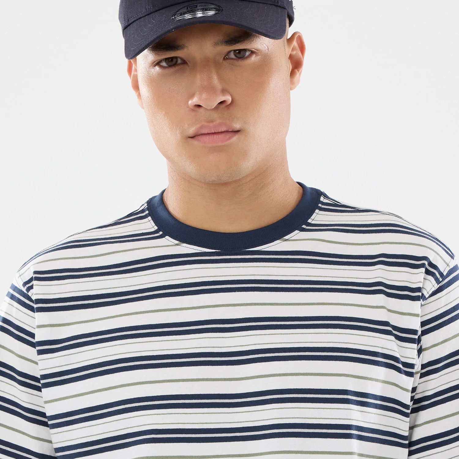 The model is wearing this New Era Boarder Stripe T-Shirt in white. 3