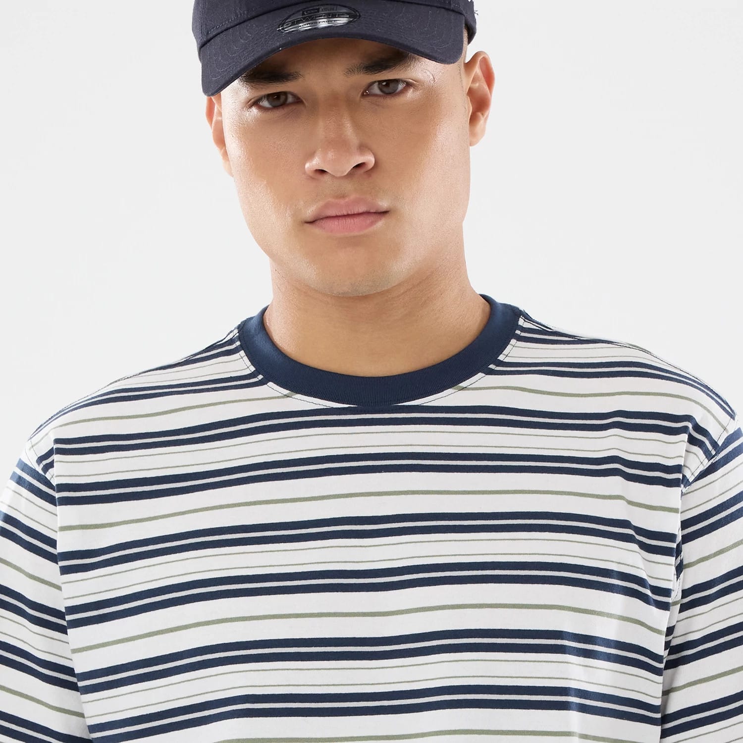 The model is wearing this New Era Boarder Stripe T-Shirt in white. 3
