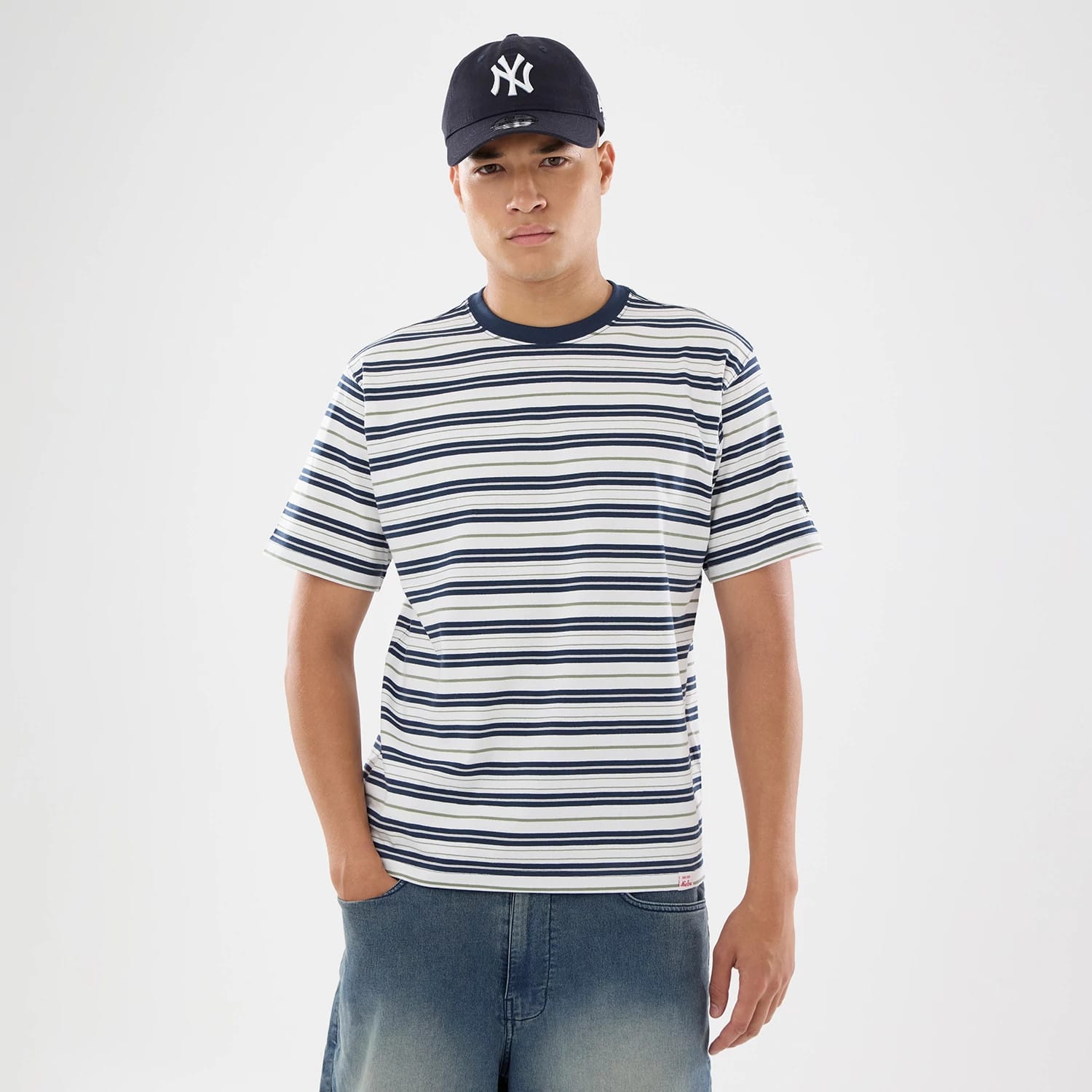 The model is wearing this New Era Boarder Stripe T-Shirt in white. 1