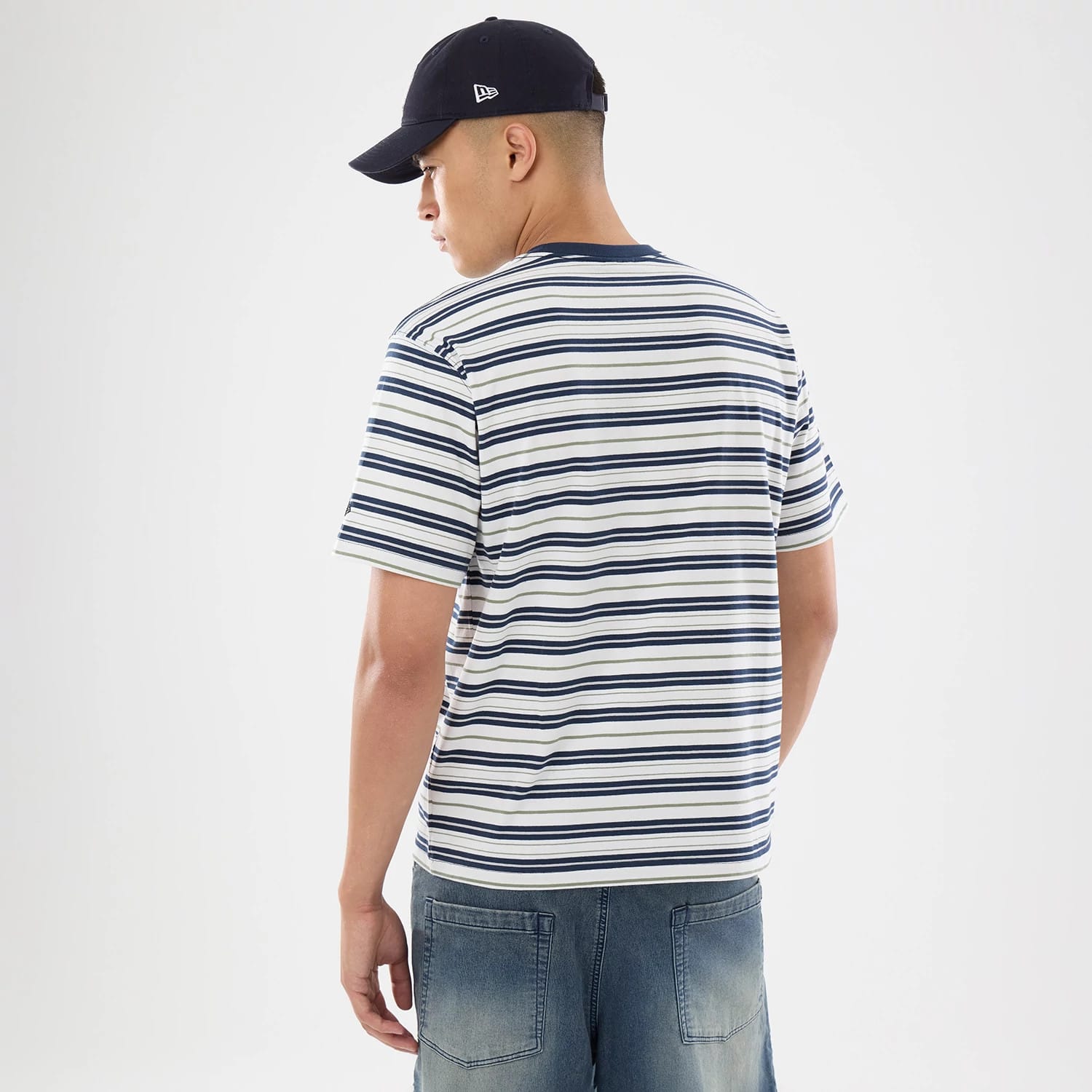 The model is wearing this New Era Boarder Stripe T-Shirt in white. 2