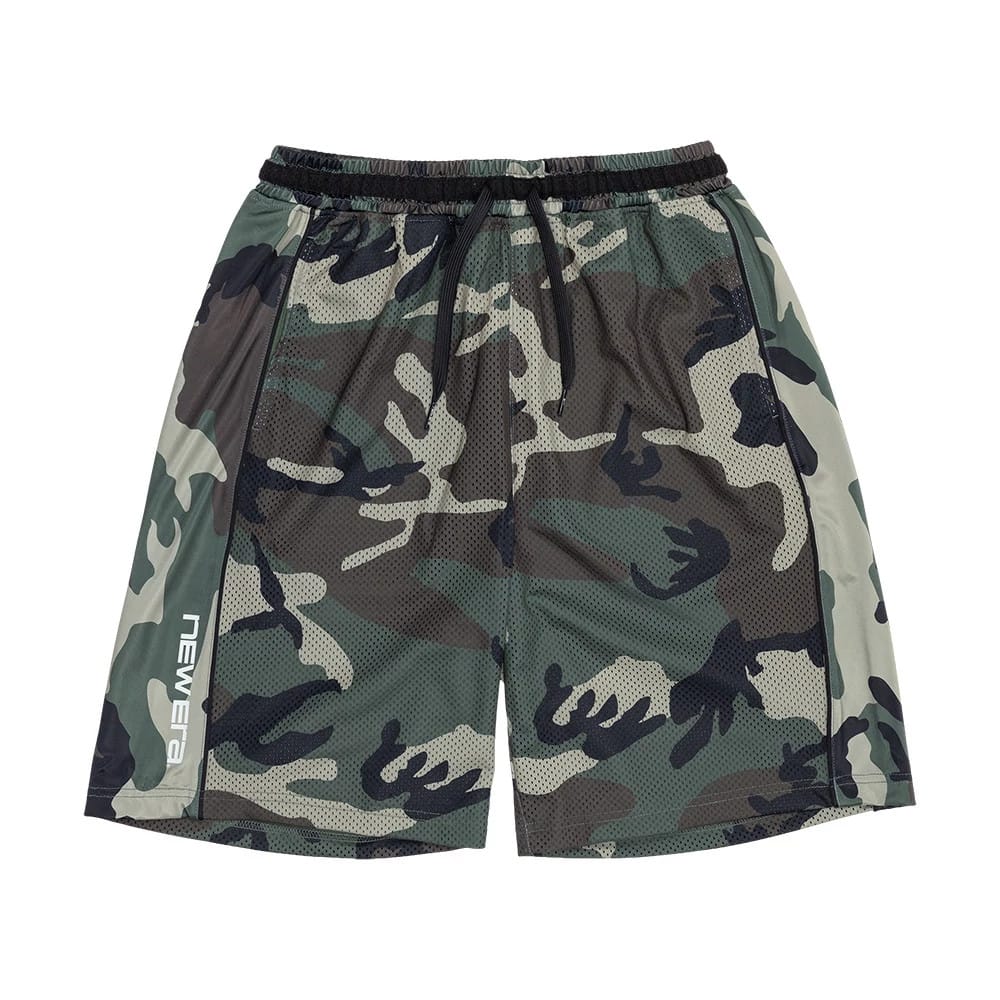 The model is wearing this New Era Bermuda Oversized Shorts in 6 Day Camo. 7