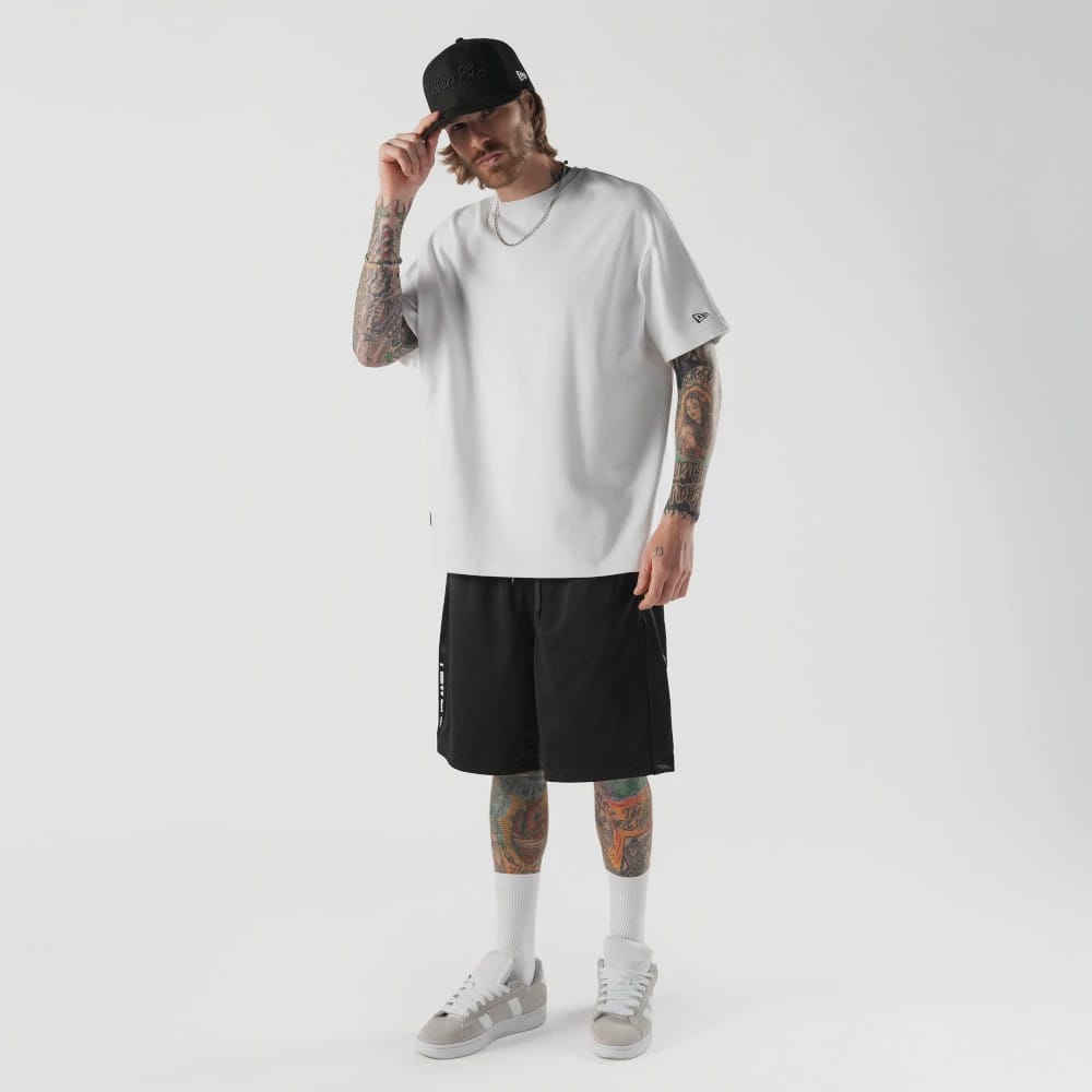 The model is wearing this New Era Bermuda Oversized Shorts in black. 5